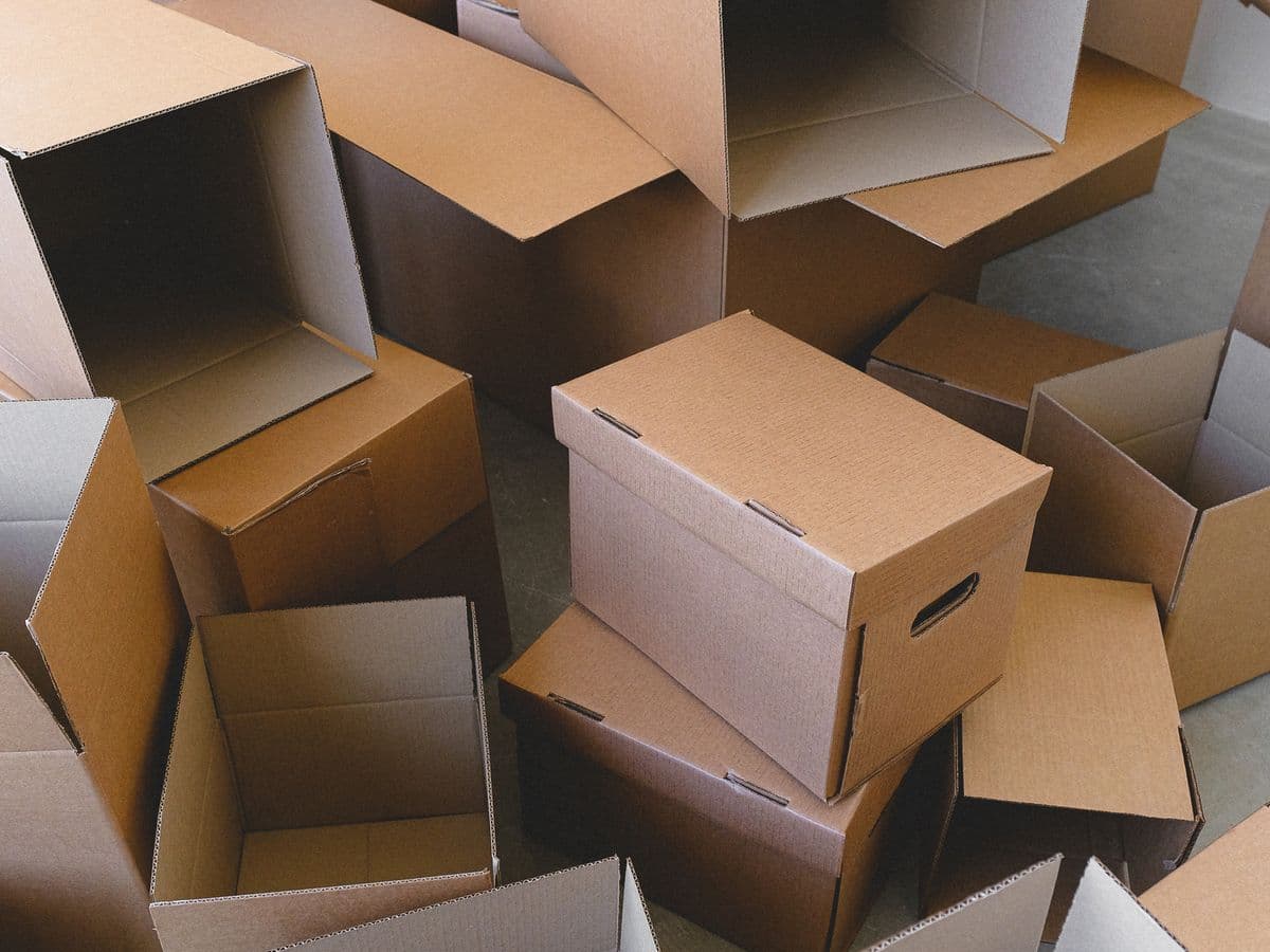 Floor covered in dozens of empty cardboard boxes