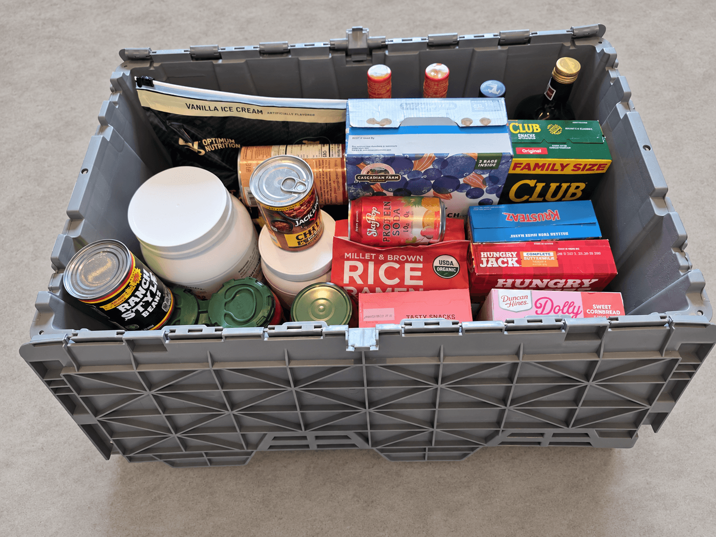 Open tote showing pantry boxes, cans, jars and bottles inside
